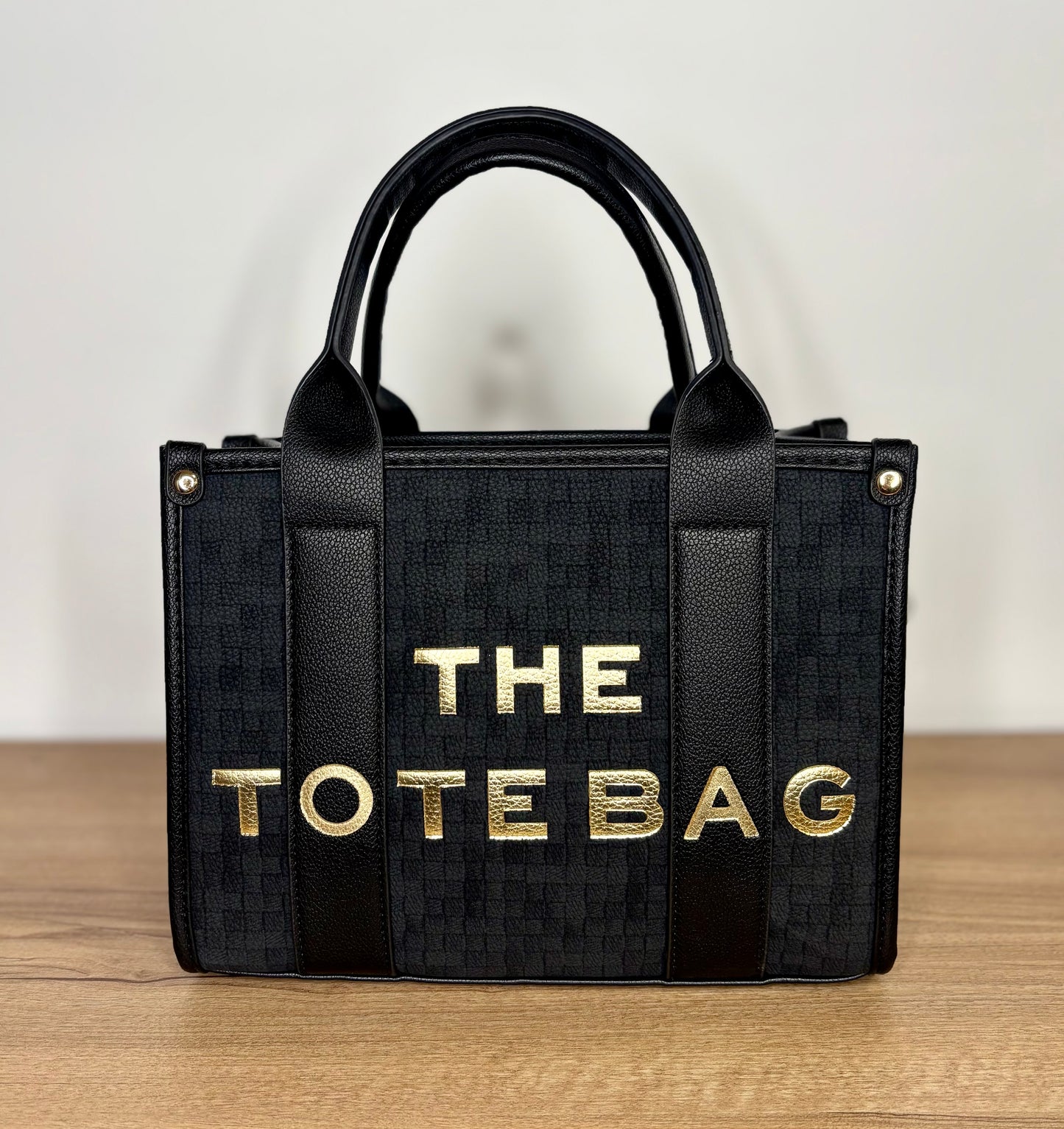 Small black and gold tote bag